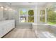 Bright bathroom with a tub and shower combination, a view of the outdoors, and modern finishes at 9009 Stourbridge Dr, Huntersville, NC 28078
