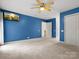 Comfortable bedroom with plush carpeting, blue walls, ample closet space, and a modern ceiling fan at 9009 Stourbridge Dr, Huntersville, NC 28078