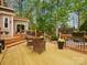 Large wooden deck overlooking a beautiful wooded yard, furnished with chairs and flower pots at 9009 Stourbridge Dr, Huntersville, NC 28078