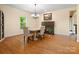 Elegant dining room featuring hardwood floors, a fireplace, and stylish lighting fixtures at 9009 Stourbridge Dr, Huntersville, NC 28078