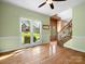 Bright, airy living room with hardwood floors, ceiling fan, and large windows offering a scenic view at 9009 Stourbridge Dr, Huntersville, NC 28078