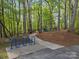 Playground with bike rack and colorful play structure surrounded by towering trees at 9009 Stourbridge Dr, Huntersville, NC 28078