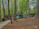 Community playground with colorful play structure surrounded by a black fence at 9009 Stourbridge Dr, Huntersville, NC 28078