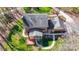 Aerial view of brick home with manicured lawns, a sunroom, and mature trees at 9951 Providence Forest Ln, Charlotte, NC 28270