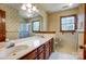 Bathroom features double sinks, decorative wallpaper, large mirror, and enclosed glass shower at 9951 Providence Forest Ln, Charlotte, NC 28270