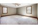 Expansive bedroom features neutral walls, two windows, and trim, offering a calming and versatile space at 9951 Providence Forest Ln, Charlotte, NC 28270