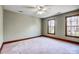 Bright bedroom with two windows providing natural light and a ceiling fan for comfort at 9951 Providence Forest Ln, Charlotte, NC 28270