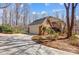 Exterior showcasing a brick home with an attached garage and a circular driveway at 9951 Providence Forest Ln, Charlotte, NC 28270