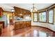 Traditional kitchen with wooden cabinets, hardwood floors and ample counter space at 9951 Providence Forest Ln, Charlotte, NC 28270