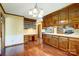 Traditional kitchen with wood cabinets, hardwood floors, and stainless steel appliances at 9951 Providence Forest Ln, Charlotte, NC 28270