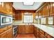 Kitchen boasting wood cabinets, hardwood floors, and stainless steel appliances at 9951 Providence Forest Ln, Charlotte, NC 28270