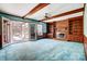 Cozy living room features exposed beam ceiling, a brick fireplace with custom built-ins and access to a sunroom at 9951 Providence Forest Ln, Charlotte, NC 28270