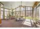 Bright sunroom with large windows offering scenic outdoor views and ceiling fans at 9951 Providence Forest Ln, Charlotte, NC 28270