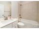 Clean bathroom with combined tub and shower featuring white tile, a vanity, and chrome fixtures at 108 Helm Ln, Mooresville, NC 28117