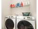 Functional laundry room with modern Samsung washer and dryer set and shelving for storage at 108 Helm Ln, Mooresville, NC 28117