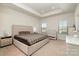 Spacious main bedroom with tray ceiling, plush carpeting, a king bed, and natural light from two windows at 108 Helm Ln, Mooresville, NC 28117