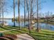 Beautiful view of the lake and a well-kept backyard with mature trees at 108 N Oakwood Dr, Kings Mountain, NC 28086