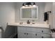 Modern bathroom with sleek white countertop, black fixtures and a large frameless mirror at 108 N Oakwood Dr, Kings Mountain, NC 28086