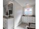 Charming bathroom with granite countertop sink, decorative window, and white cabinets at 108 N Oakwood Dr, Kings Mountain, NC 28086