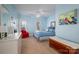 Comfortable bedroom featuring two windows, a ceiling fan, and blue walls with a chest at the foot of the bed at 108 N Oakwood Dr, Kings Mountain, NC 28086