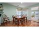 Bright dining area featuring wood floors and a view to a sunroom at 108 N Oakwood Dr, Kings Mountain, NC 28086