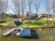 Exterior view of a covered boat dock and lakeside home surrounded by mature trees at 108 N Oakwood Dr, Kings Mountain, NC 28086