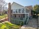 Expansive exterior view of home with large windows, a brick chimney, and back deck at 108 N Oakwood Dr, Kings Mountain, NC 28086