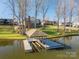 Charming view of a covered dock and the lakeside home in the background at 108 N Oakwood Dr, Kings Mountain, NC 28086