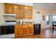 Functional kitchen with wood cabinets, stainless steel sink, and appliances at 108 N Oakwood Dr, Kings Mountain, NC 28086