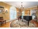 Stylish living room with a grand piano, decorative rug, and custom lighting at 108 N Oakwood Dr, Kings Mountain, NC 28086