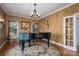 Stylish living room with a grand piano, decorative rug, and custom lighting at 108 N Oakwood Dr, Kings Mountain, NC 28086