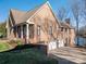 Brick home featuring a 3-car garage and view of the lake at 108 N Oakwood Dr, Kings Mountain, NC 28086