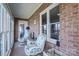 Relaxing sunroom with brick walls, two chairs, and lots of sunlight at 108 N Oakwood Dr, Kings Mountain, NC 28086