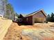 Home exterior with a rear two-car garage and a retaining wall; harmonizing architectural elegance and practical landscaping at 1199 Brunson Rd, Fort Lawn, SC 29714