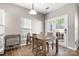 Cozy dining area with wood table, four chairs, wine rack and French doors leading to the outside at 12419 Swan Wings Pl, Huntersville, NC 28078