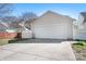 Detached garage with a wide driveway and partial fence at 12419 Swan Wings Pl, Huntersville, NC 28078