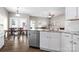 Open-concept kitchen view with stainless steel dishwasher and sink, and a connected dining and living space at 12419 Swan Wings Pl, Huntersville, NC 28078