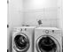 Clean and functional laundry room featuring a modern washer and dryer set with shelving at 12419 Swan Wings Pl, Huntersville, NC 28078