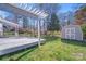 Backyard featuring a wooden deck with a pergola and a storage shed on a lush green lawn at 13732 Strathaven Dr, Matthews, NC 28105