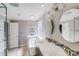 Bathroom with wood-look floors, double vanity with decorative backsplash, soaking tub, and glass-enclosed shower at 13732 Strathaven Dr, Matthews, NC 28105