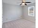 Bedroom featuring a neutral color scheme, carpeted floors, a ceiling fan, and a window offering natural light at 13732 Strathaven Dr, Matthews, NC 28105