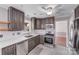 Well-equipped kitchen featuring stainless appliances, gray cabinets, and tiled backsplash and floors at 13732 Strathaven Dr, Matthews, NC 28105