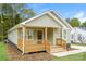 Single-story home with a cozy front porch and neat landscaping at 1429 Edgewood Dr, Rock Hill, SC 29730