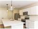 Modern kitchen featuring white cabinets, stainless steel appliances, and a large island with pendant lights at 1429 Edgewood Dr, Rock Hill, SC 29730