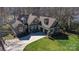 Aerial shot showcasing a spacious home with lush green lawn, and a long private driveway at 147 Pearl Bay Dr, New London, NC 28127