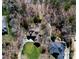 Aerial view of the property featuring mature trees and a well-manicured lawn at 147 Pearl Bay Dr, New London, NC 28127