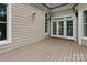 Spacious back deck with neutral-toned siding and sliding glass doors for seamless indoor-outdoor living at 147 Pearl Bay Dr, New London, NC 28127
