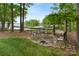 Backyard seating area, dock, and waterfront access on a sunny day at 147 Pearl Bay Dr, New London, NC 28127