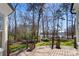 Scenic backyard view from the deck, featuring lush greenery and a peaceful lake at 147 Pearl Bay Dr, New London, NC 28127