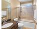 Bathroom featuring dark wood cabinets, granite countertops, and shower-tub combo at 147 Pearl Bay Dr, New London, NC 28127